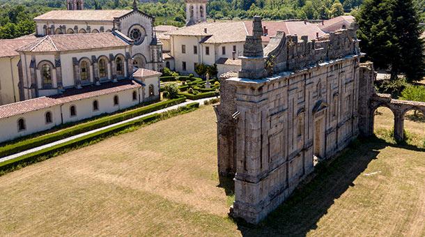 Aerial view of an ancient monastery with historic architecture and gardens.